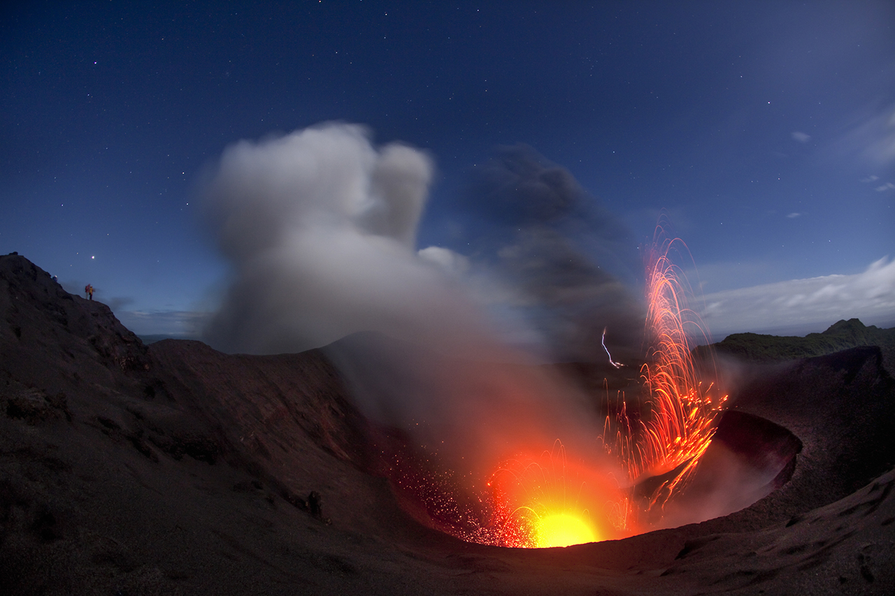 Tourists and scientist watching Yasur Volano with strombolian eruptions at night
